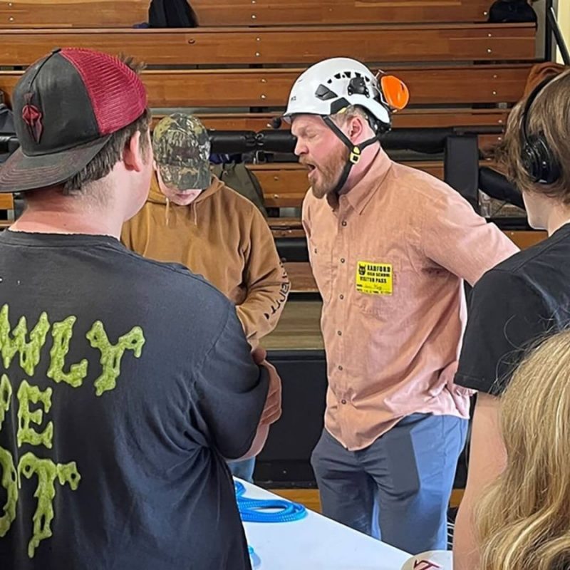 Jamie King [white helmet], a Virginia Tech Arborist, addresses a group of students during the "Mingle Like You Mean It" networking event. 